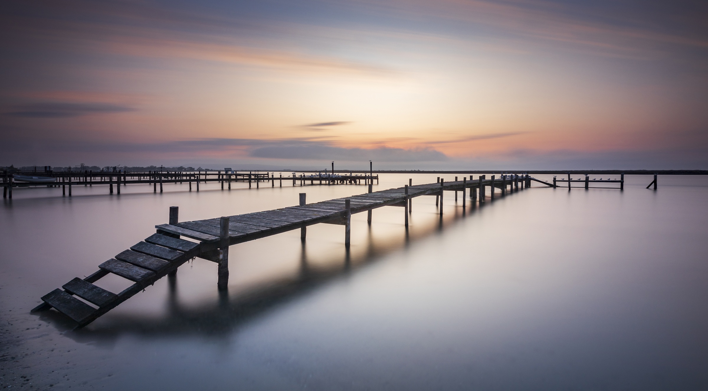 Quiet timber jetties extending into still water at Rooibaai, Velddrif.