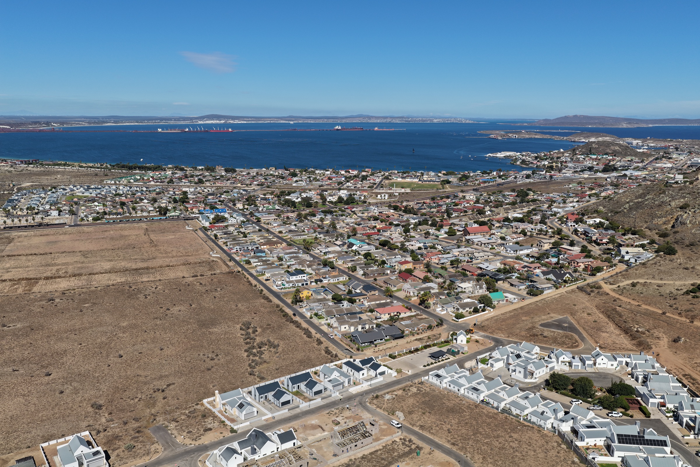 Aerial panorama of Saldanha Bay, its neighbourhoods, port and working coastline.
